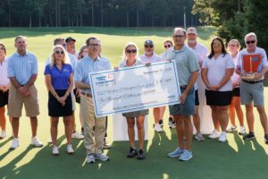 Winthrop P. Rockefeller Cancer Institute Group holding check